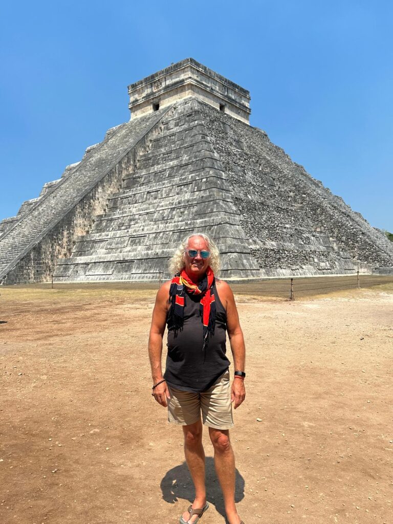 Rik standing in front of the ancient stepped pyramid at Chichen Itza representing the goal hierarchy that unlocks personal and business goals.
