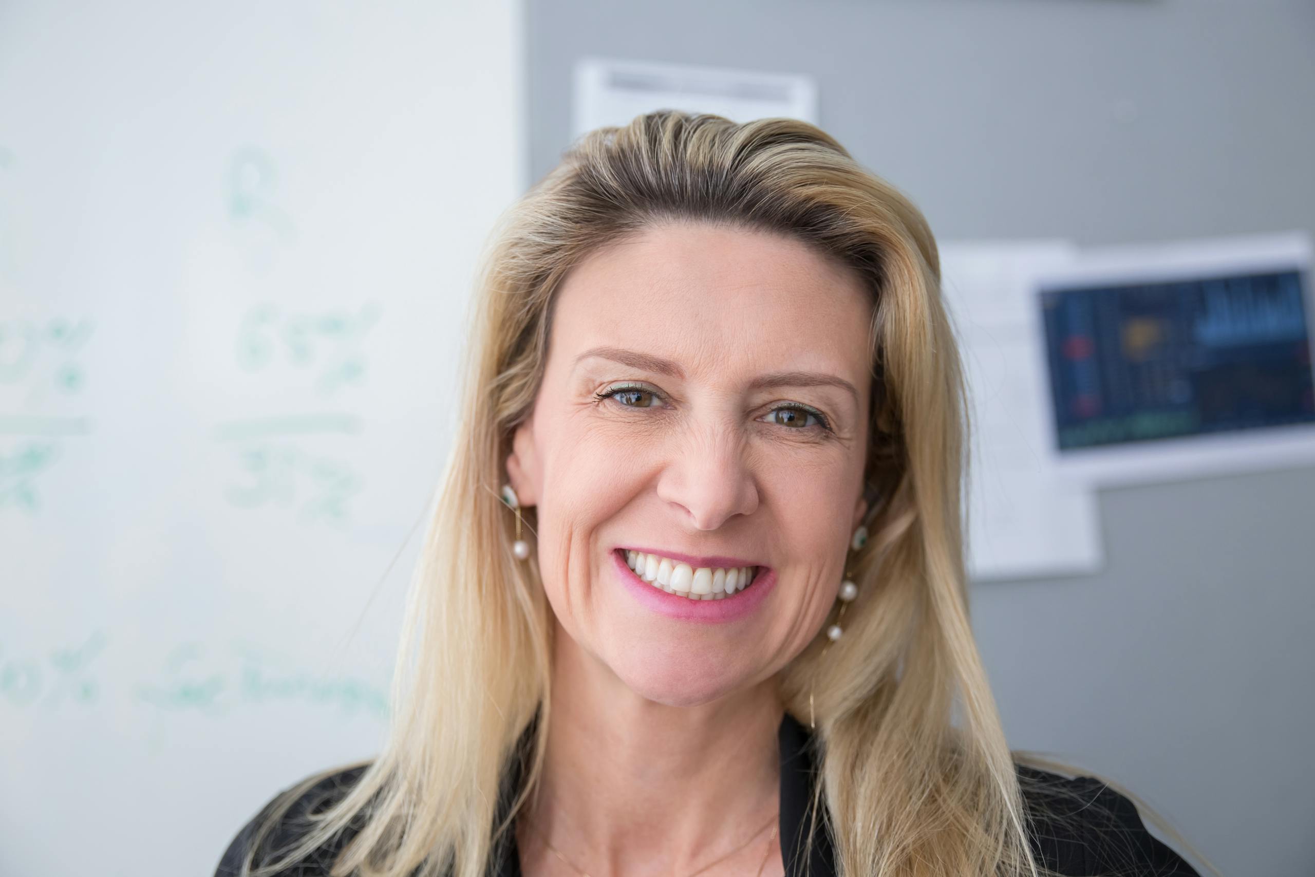 Close-up of a smiling woman with a bright expression indoors in Portugal.