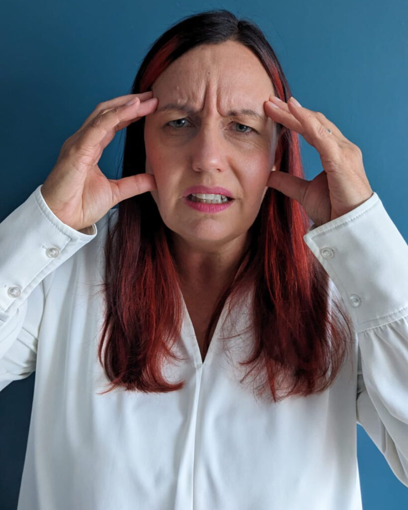 An image of business coach Gil Devlin. Depicting a director feeling overwhelmed from managing distractions and non-essential noise. © Gil Devlin 2022