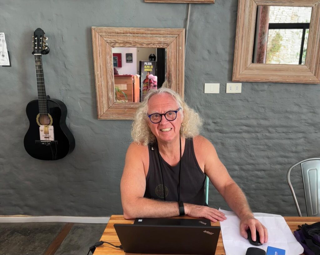 Rik Lambert working remotely at a laptop in Montevideo, Uruguay, building websites and managing systems for business growth.