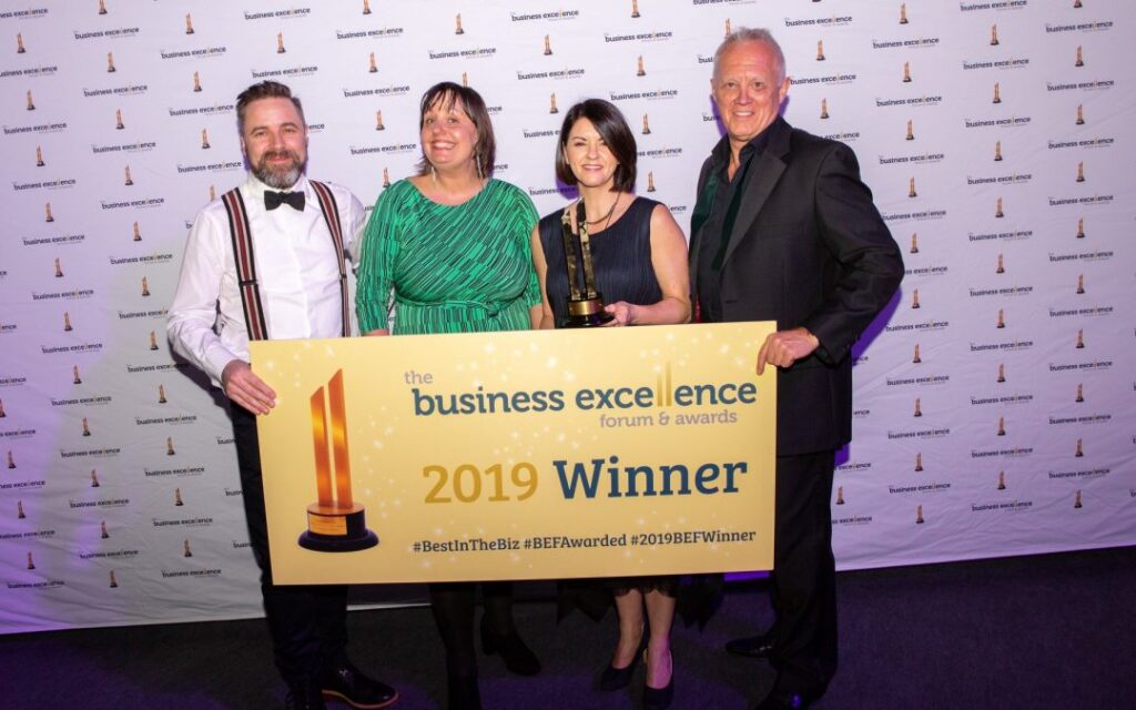 Gil Devlin celebrating with Cox London founders winning the Fastest Growing Company award, demonstrating scale up company growth.