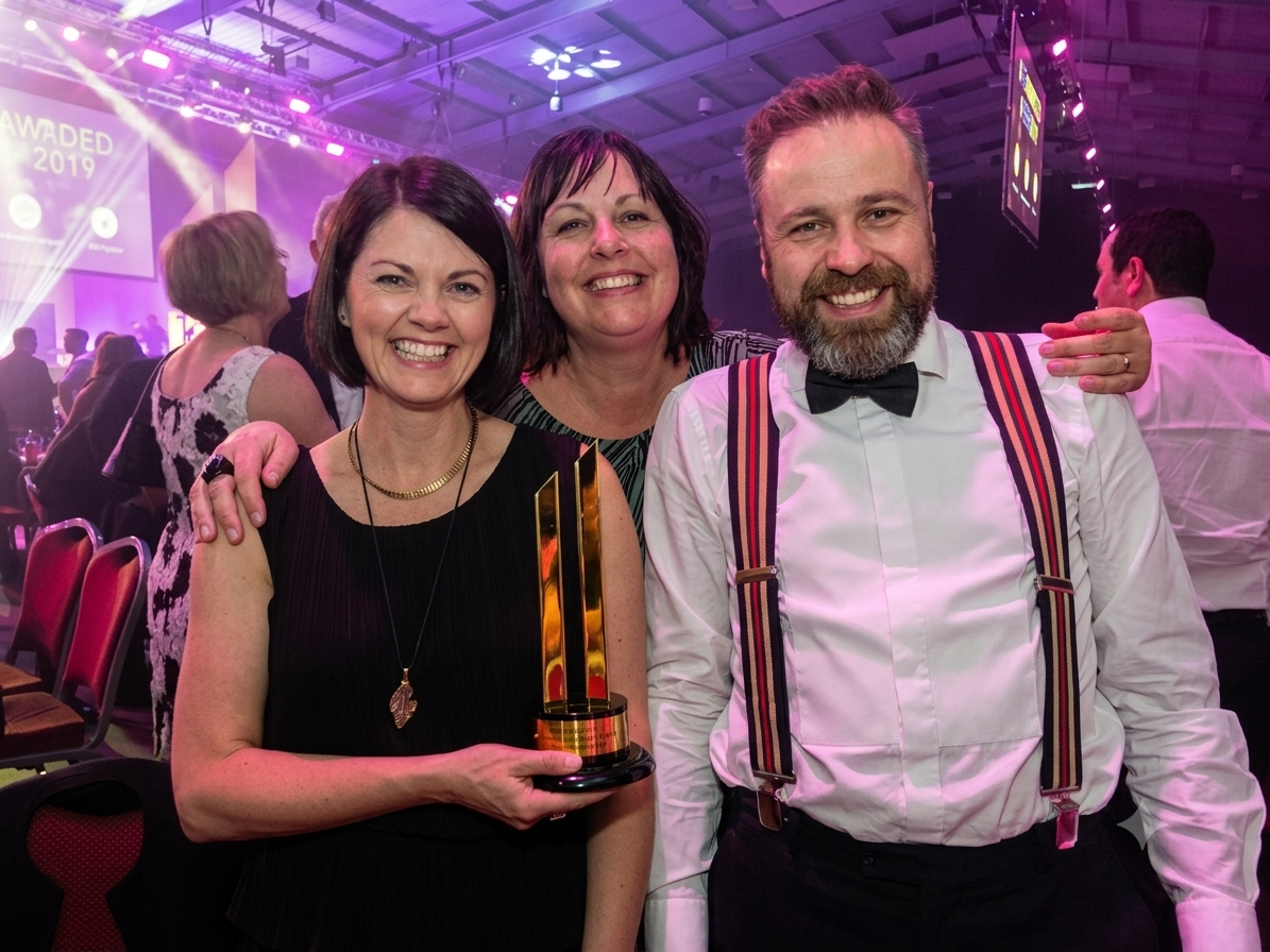 Chris and Nicola Cox with Gil Devlin after winning the Fastest Growing Company award at BizX 2019, showcasing how a structured strategy for growing business transforms an ambitious SME into a thriving scale-up